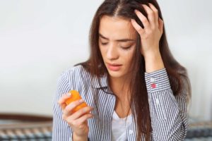 a woman starts to feel dizzy and strange after self medicating with prescription drugs