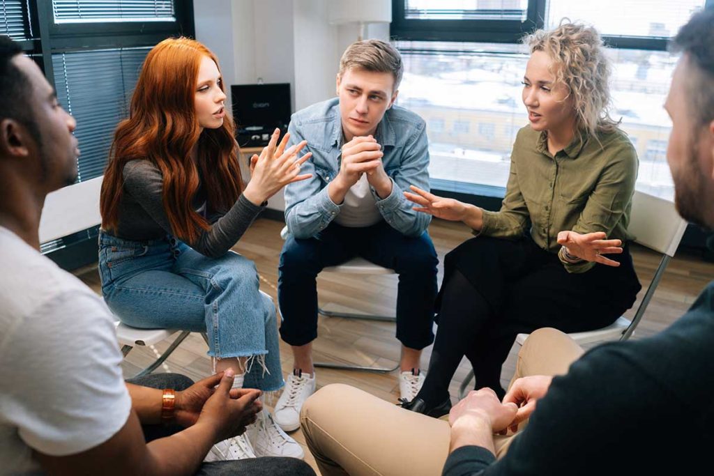 people in a group therapy sessions discuss residential vs inpatient treatment