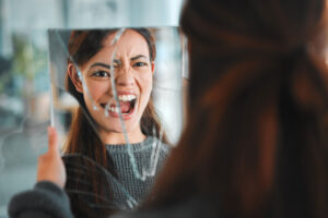 artistic representation of a womans anger in broken mirror