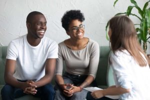 man and woman on couch learn about the benefits of family therapy