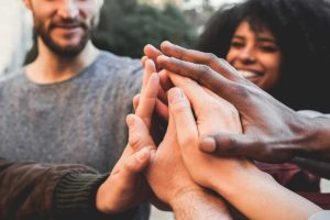 Multiple hands gathering in support