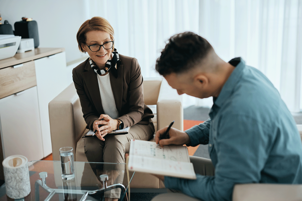 a man works hard with his counselor in his motivational enhancement therapy session