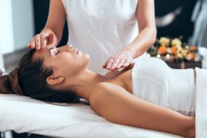 a woman receives a therapeutic massage as part of her holistic therapy treatment