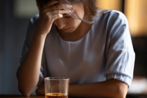 a woman struggles to keep concealing the signs of her alcohol addiction