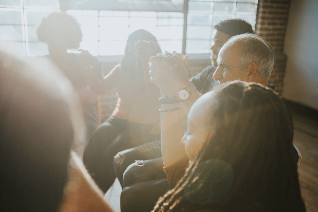 individuals in an outpatient addiction treatment program attend group therapy