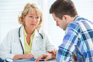 a man discusses ketamine treatment for addiction with his treatment specialist