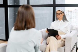 a woman meets her new therapist in gender specific womens addiction treatment 