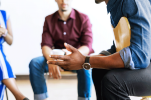 a man opens up in group therapy during drug detox