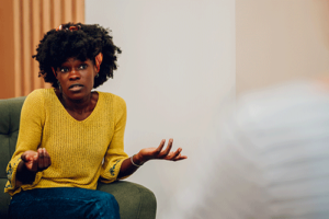 a woman starts to open up in her individual addiction therapy program