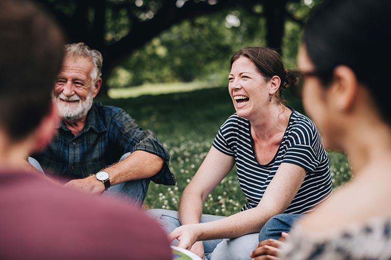 Patients sitting outside in a circle discussing coping skills to help with substance abuse