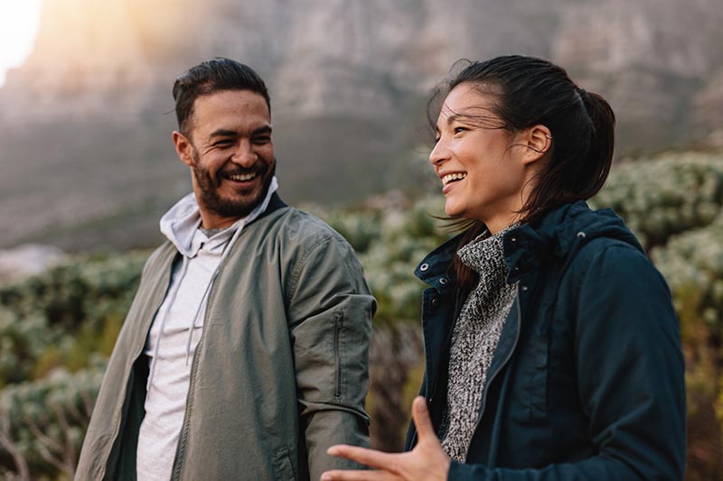 Woman and man happily talking about recovering from substance abuse