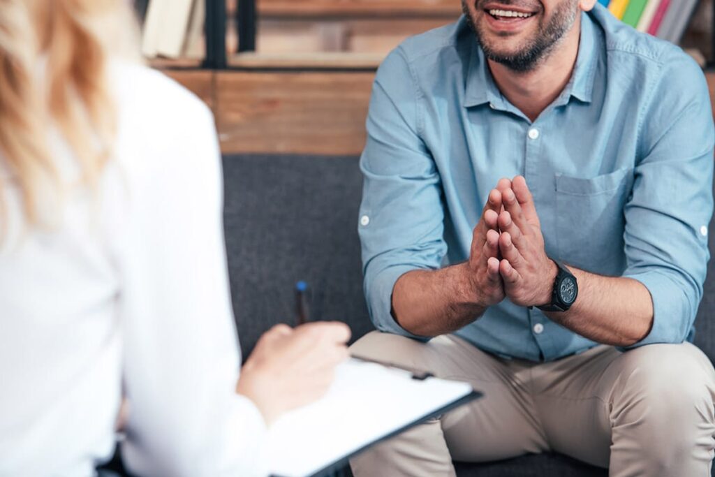 a man opens up to his therapist in a psychotherapy session