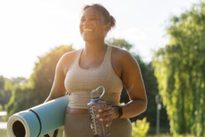 a woman does yoga in the park to improve her mood