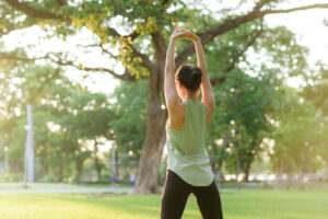 a woman practices yoga therapy to improve her mental health