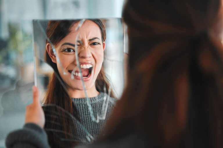 a woman with anger management issues screaming to a broken mirror