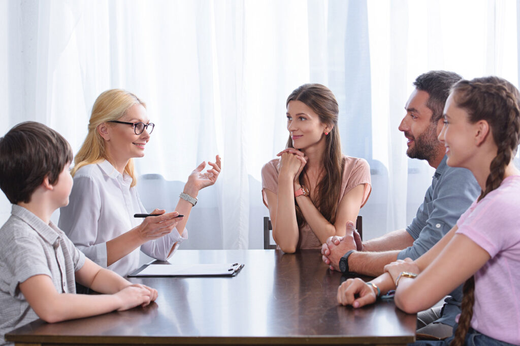 a counselor guides a family through family therapy activities