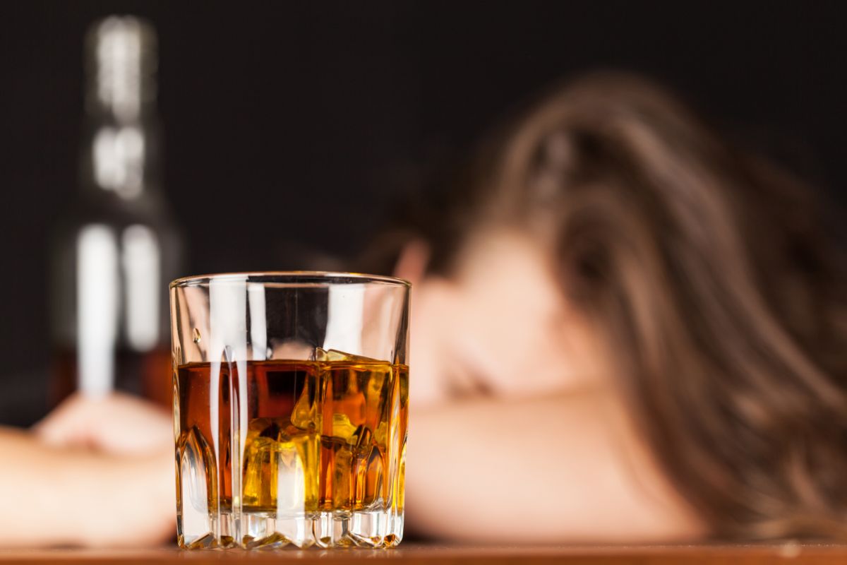 woman drinking at a bar struggles with alcoholism