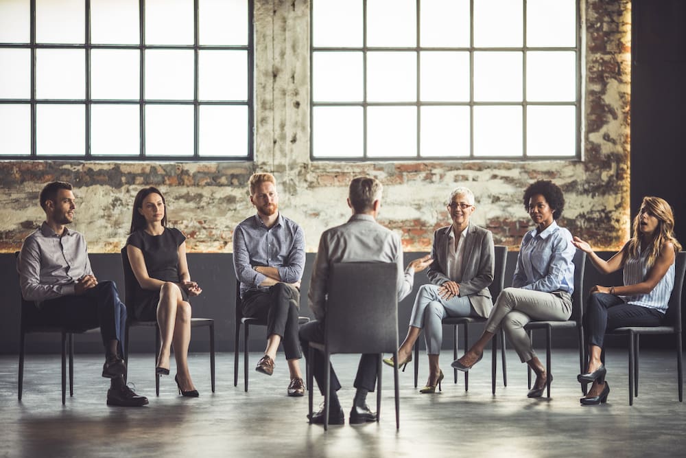 parents and loved ones sitting at an al-anon meeting