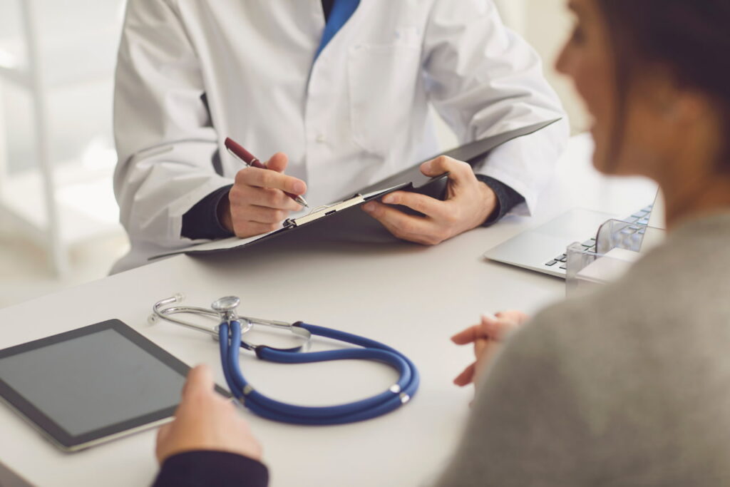 a doctor discussing the dangers of adderall addiction with a patient