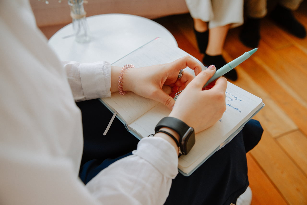 Woman struggling with pure OCD holding a pen and notepad