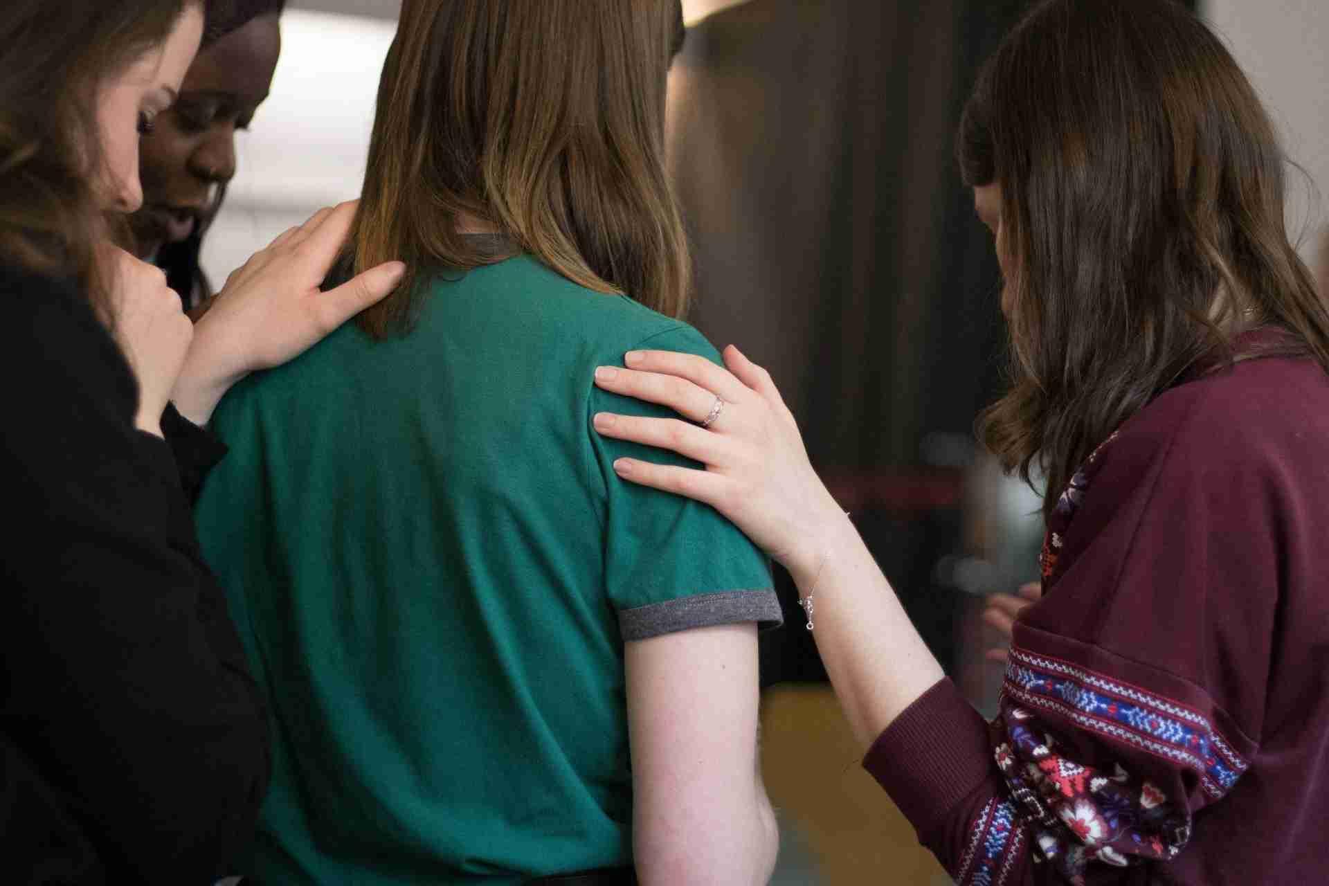 Group of women offering emotional support during a recovery or mental health support session.
