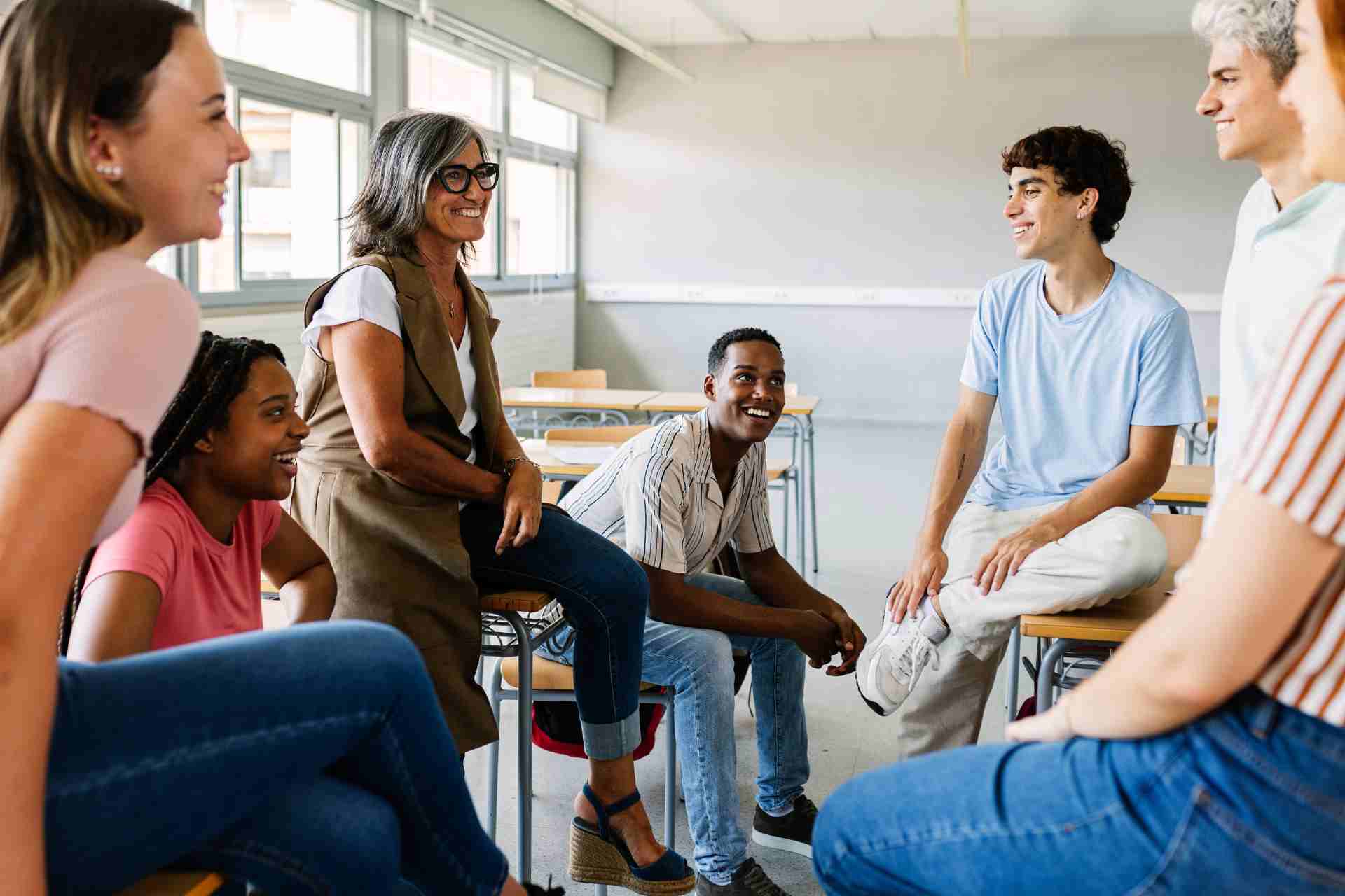 Young adults participating in a supportive group therapy discussion with a counselor
