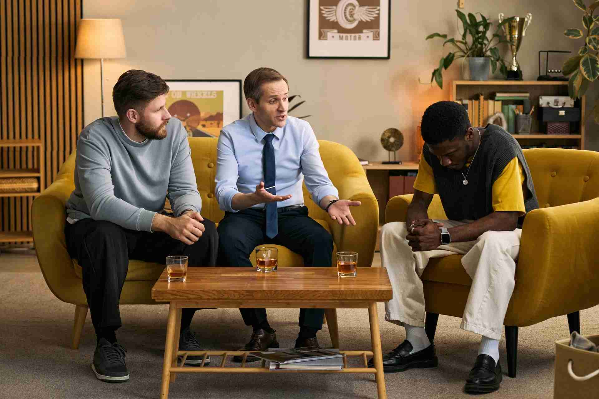 Therapist and support team speaking with a person struggling with alcohol use disorder