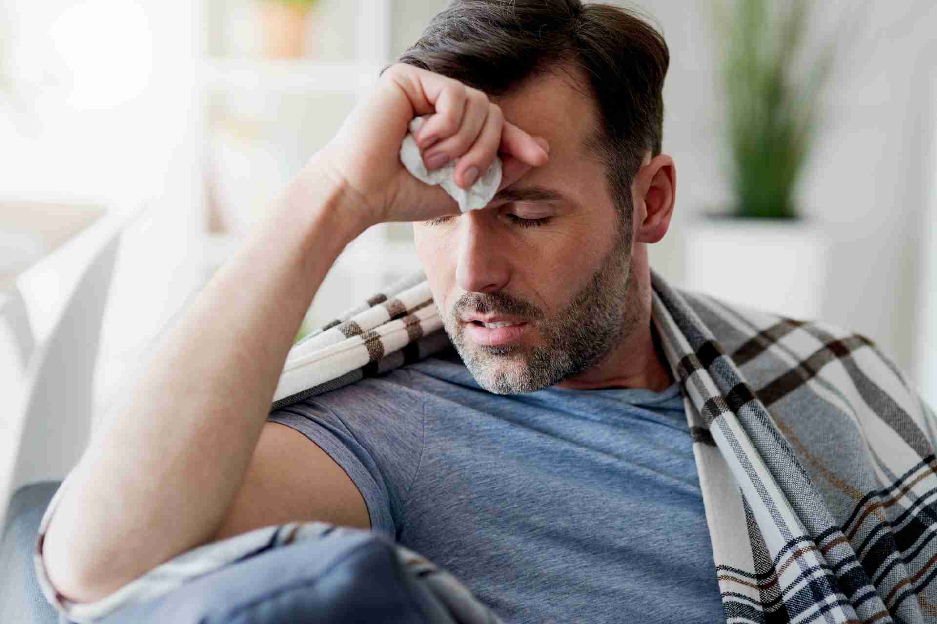 Man experiencing fever-like symptoms during alcohol withdrawal recovery