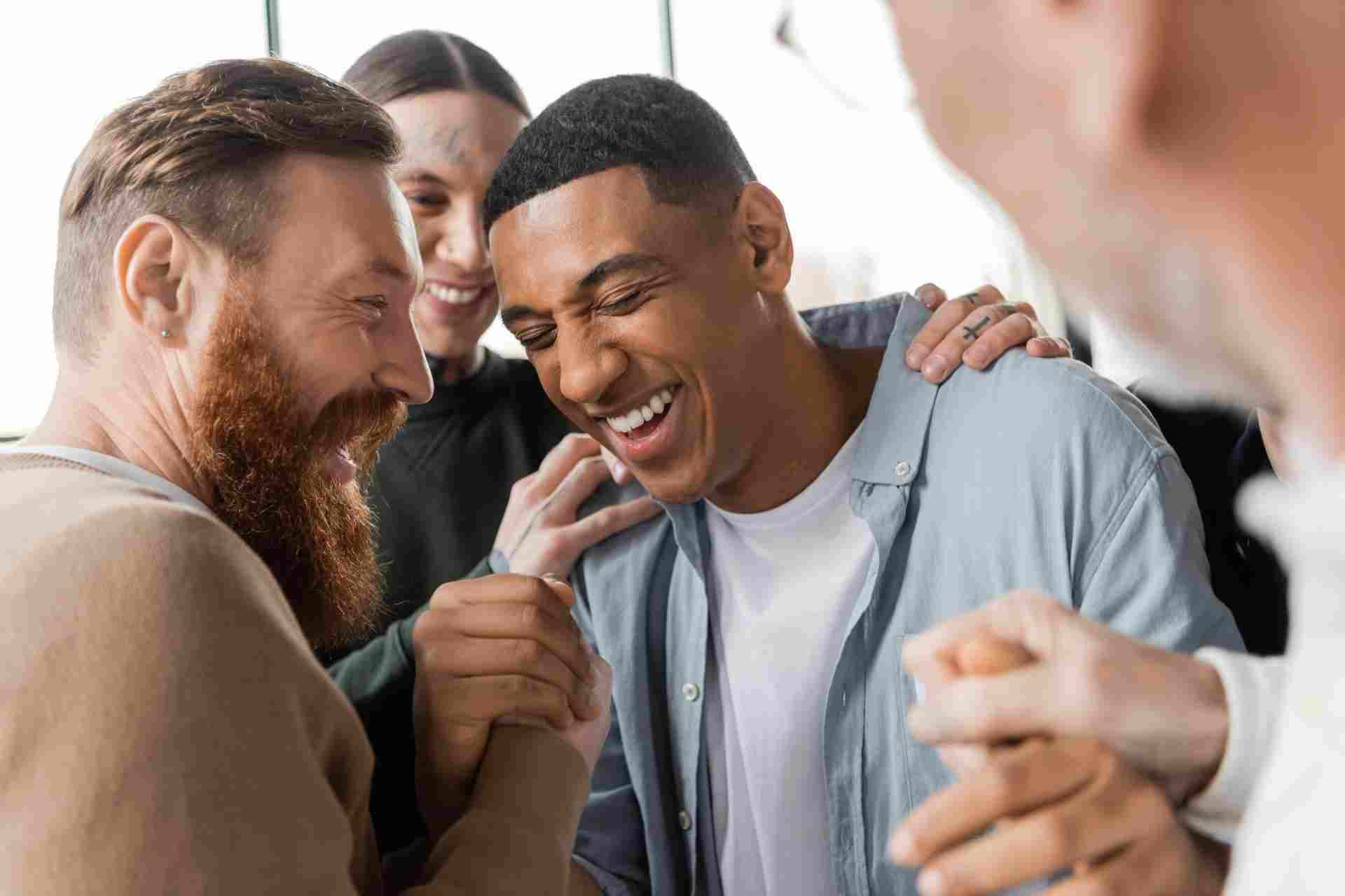 Individuals celebrating progress during a peer support session in addiction recovery treatment